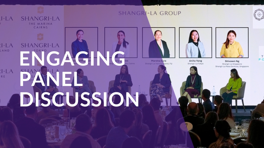 Moderator guiding a panel discussion with multiple microphones.