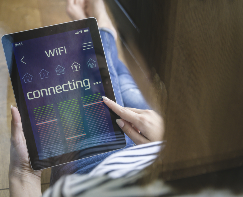 Young woman with tablet with smart home control functions