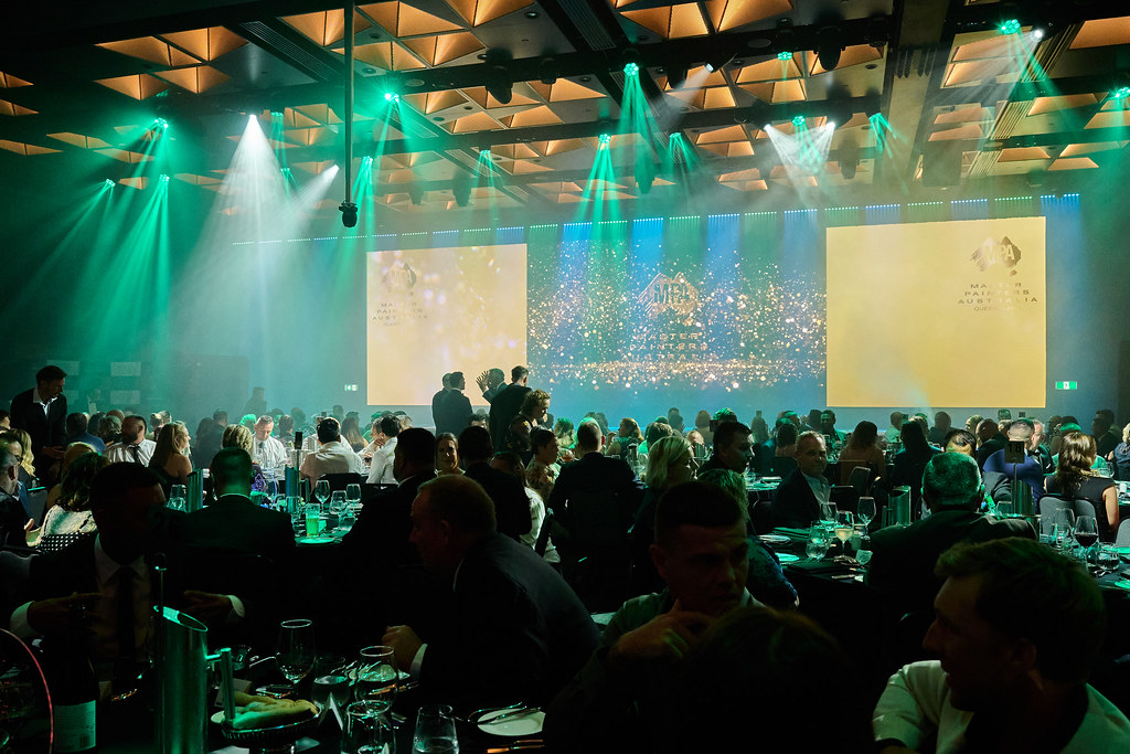 Guests enjoying dinner during an awards night in a decorated ballroom