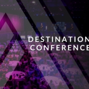 Destination Conference Banner Conference participants watching a stage presentation.