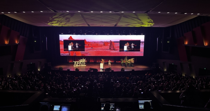 Conference Centre AV Installation with UHD LED Screens. Live conference audience watching an Aboriginal, first nations performance.
